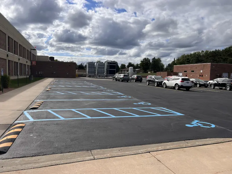 building parking lot with new sealcoating and striping