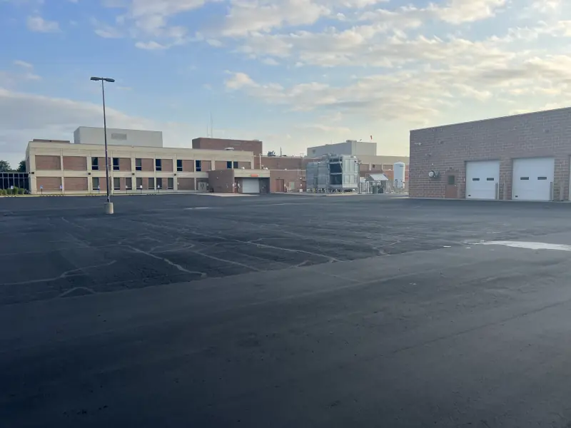 parking lot with sealcoating but no stripes yet